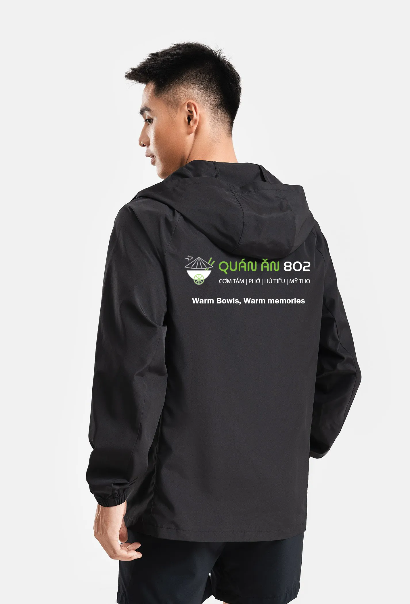 Staff uniform windbreaker jacket back print showing Quán Ăn 802 logo